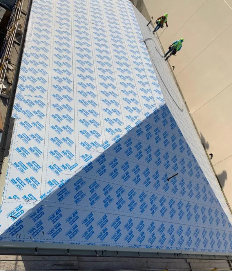 Professional roofers installing underlayment on a metal roof in Saratoga Springs